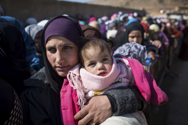 Newly arrived Syrian refugee women and children queue for registration and aid distribution in the town of Arsal, Lebanon, February 17 2014. © UNHCR/A. McConnell
