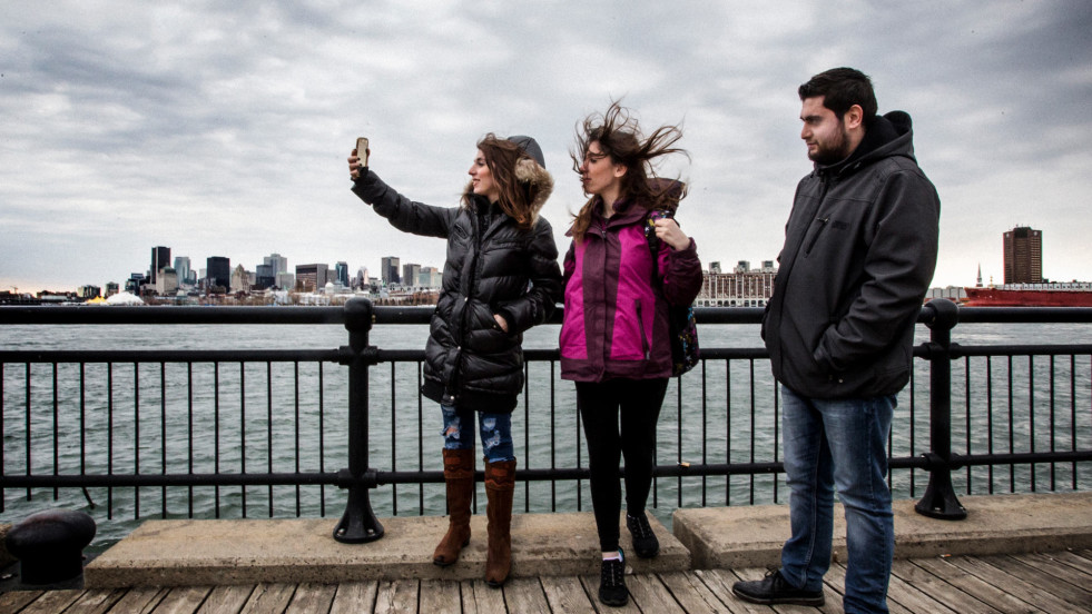 Kevork and his sisters take pictures of the Montreal skyline.