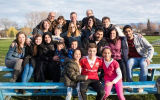 Mohammad, Sahar and their children gather for a photo with their sponsors and volunteers during an outing to the park.