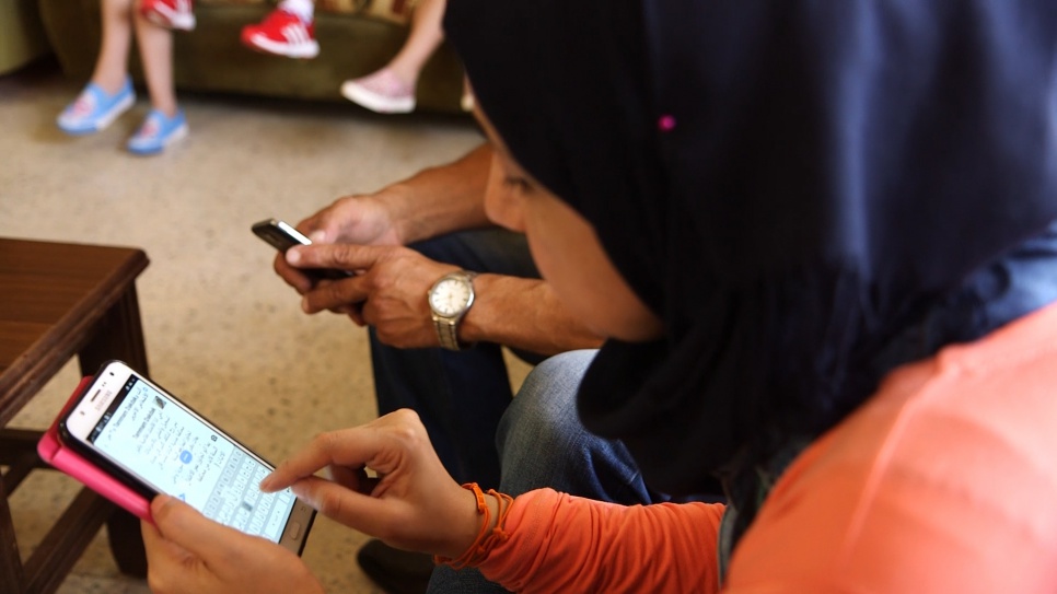 Oum Nidal manages a Facebook group popular with fellow Syrian refugees in Lebanon. © UNHCR