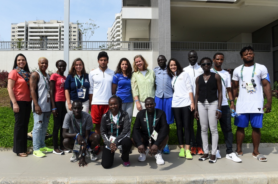 The Refugee Olympic Team poses with UN Deputy High Commissioner for Refugees Kelly Clements and staff in Rio’s Olympic Village. © UNHCR