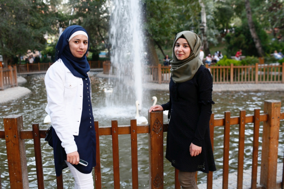 Fatima (left) and and fellow student Rawan take a moment to relax in the park. Fatima is hoping to study for a masters and a PhD, and plans to returns to Syria when the war is over. © UNHCR/Ali Unal