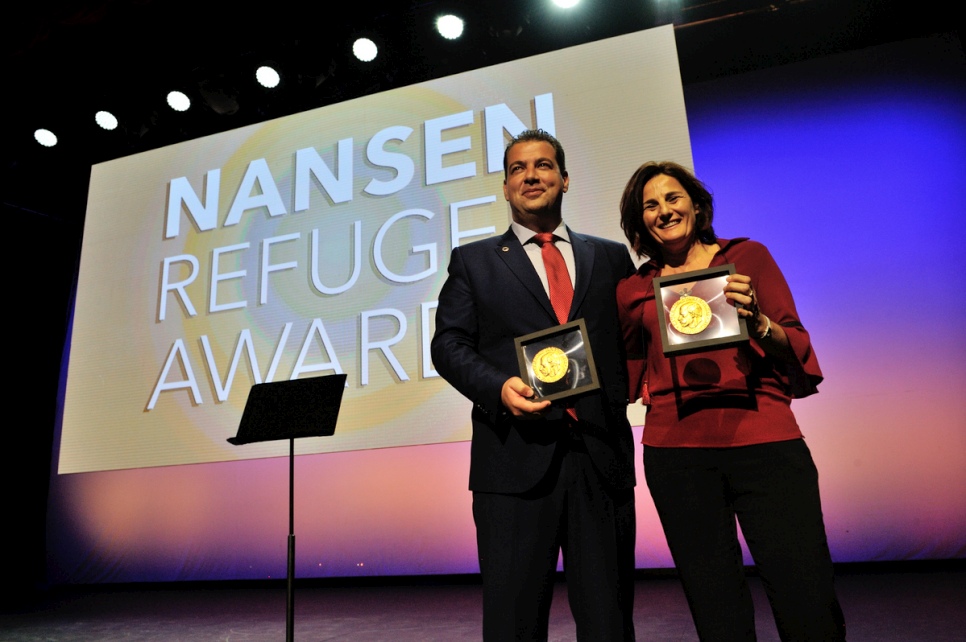 Joint winners the Hellenic Rescue Team and Efi Latsoudi of PIKPA village on Lesvos hold the humanitarian awards they received at a ceremony in Geneva. © UNHCR/Mark Henley