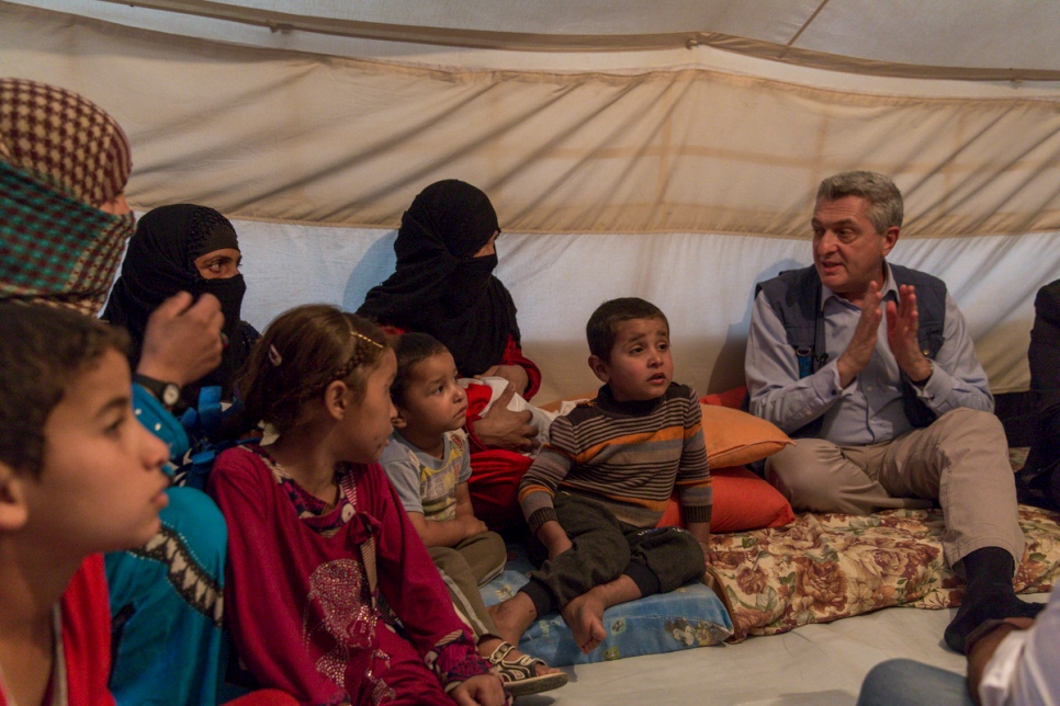 United Nations High Commissioner for Refugees Filippo Grandi speaks with a displaced family in their tent at Debaga camp in the Kurdistan Region of Iraq. © UNHCR/Ivor Prickett