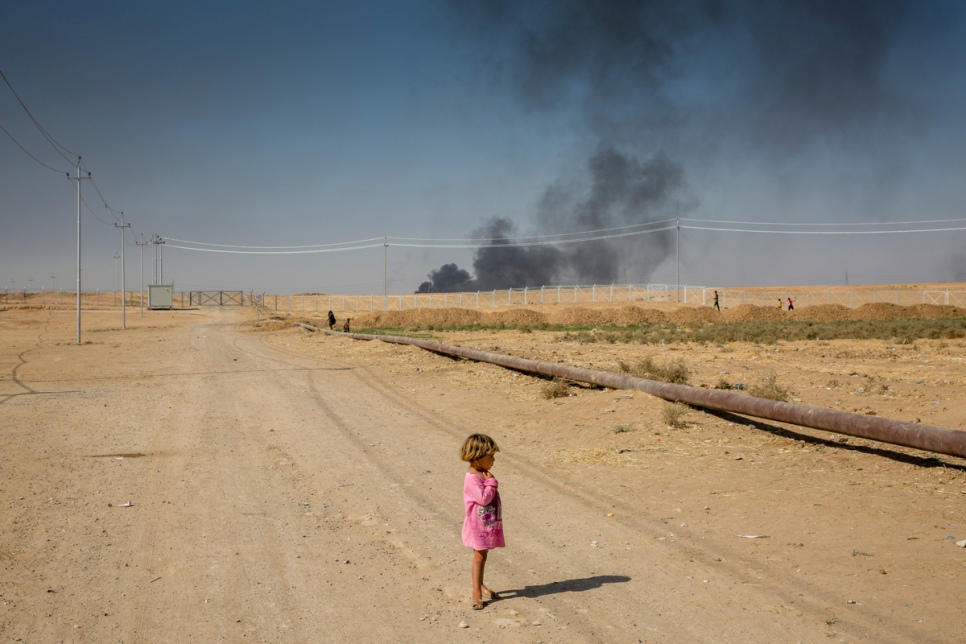 A displaced child stands on the edge of Debaga camp in the Kurdistan Region of Iraq. The camp lies just 40 kilometres from the front line in the military push to retake Mosul. © UNHCR/Ivor Prickett