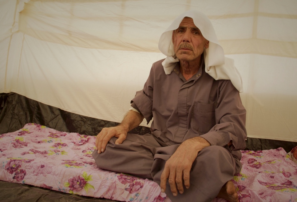 A displaced Iraqi man sits in a tent at Zelikan camp in the Kurdistan Region of Iraq. © UNHCR/Rasheed Hussein Rasheed 
