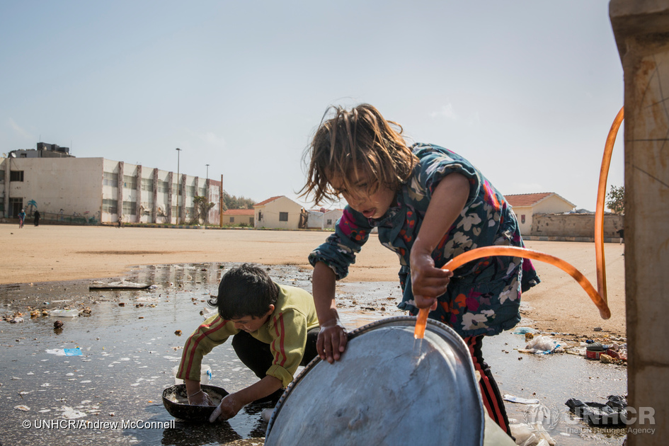 Children wash dishes at a water point in the Pioneer Camp for internally displaced persons in Tartous, Syria. The camp houses 423 families, (2272 individuals) mostly from Aleppo. 