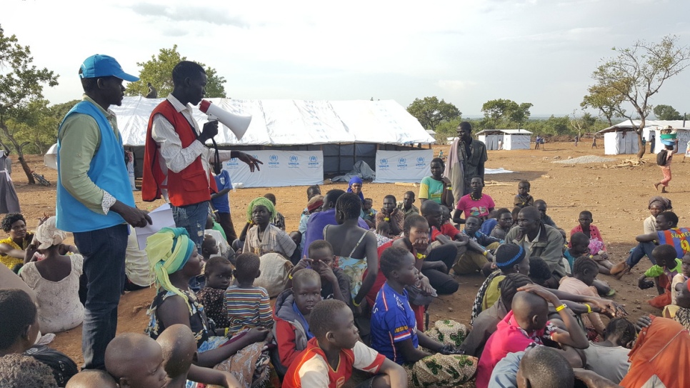 Newly-arrived refugees from South Sudan are given information about services they can access at the reception centre in Bidibidi Settlement, Uganda. © UNHCR/Massoumeh Farman-Farmaian