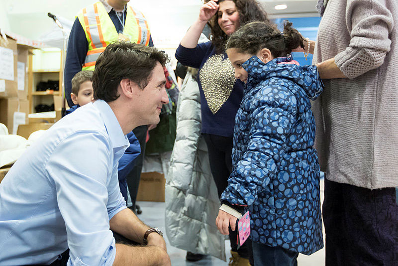 Prime Minister Justin Trudeau greets Syrian refugees upon arrival in Canada in late 2015. Adam Scotti photograph courtesy of the PMO