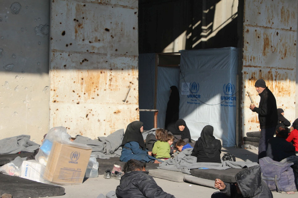 Displaced residents from east Aleppo rest at a centre where UNHCR and other agencies provide shelter and aid including clothing and thermal blankets in west Aleppo, Syria. © UNHCR/Dima Alnaeb