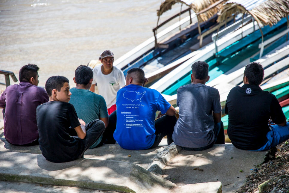A boy from Honduras waits with a group of young men to board a boat in La Técnica, Guatemala. © UNHCR/Tito Herrera