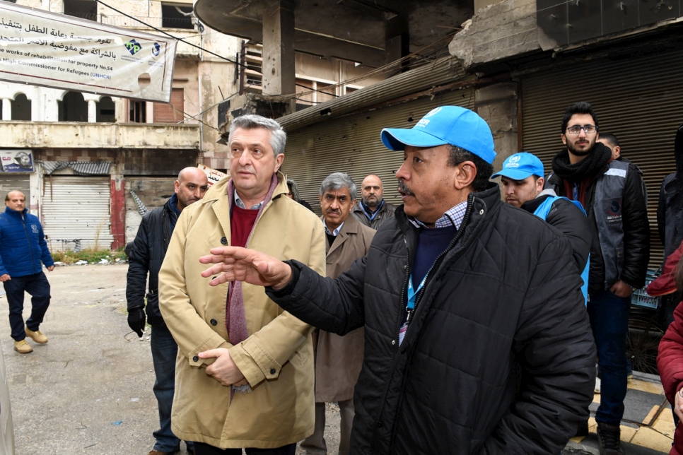 UN High Commissioner for Refugees Filippo Grandi listens to a brief about UNHCR shelter rehabilitation assistance from a UNHCR shelter officer in Al-Hamedia neighborhood of Old City district of Homs, Syria. © UNHCR/Bassam Diab