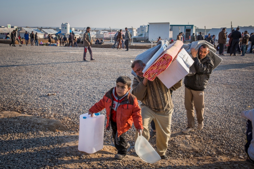 An Iraqi family who fled fighting in Mosul collect aid items at Hasansham camp, Iraq, January 23 2017. They had fled militant held west Mosul three days before by crossing the Tigris River at night in a small wooden boat.  © UNHCR/Ivor Prickett