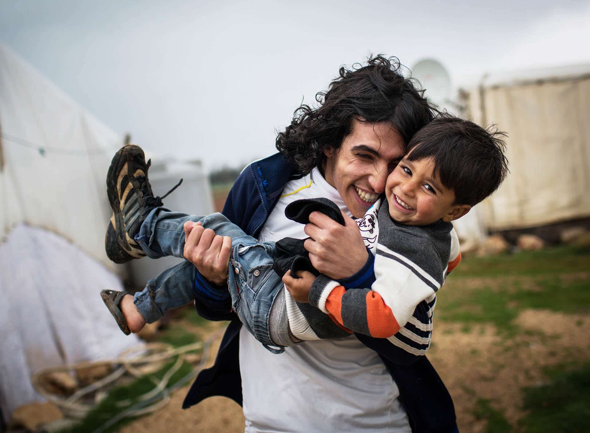 3 year-old Ashraf, and his brother Hany, pictured outside their family's shelter at an informal tented settlement in the Bekaa Valley, Lebanon, on 12 March 2014