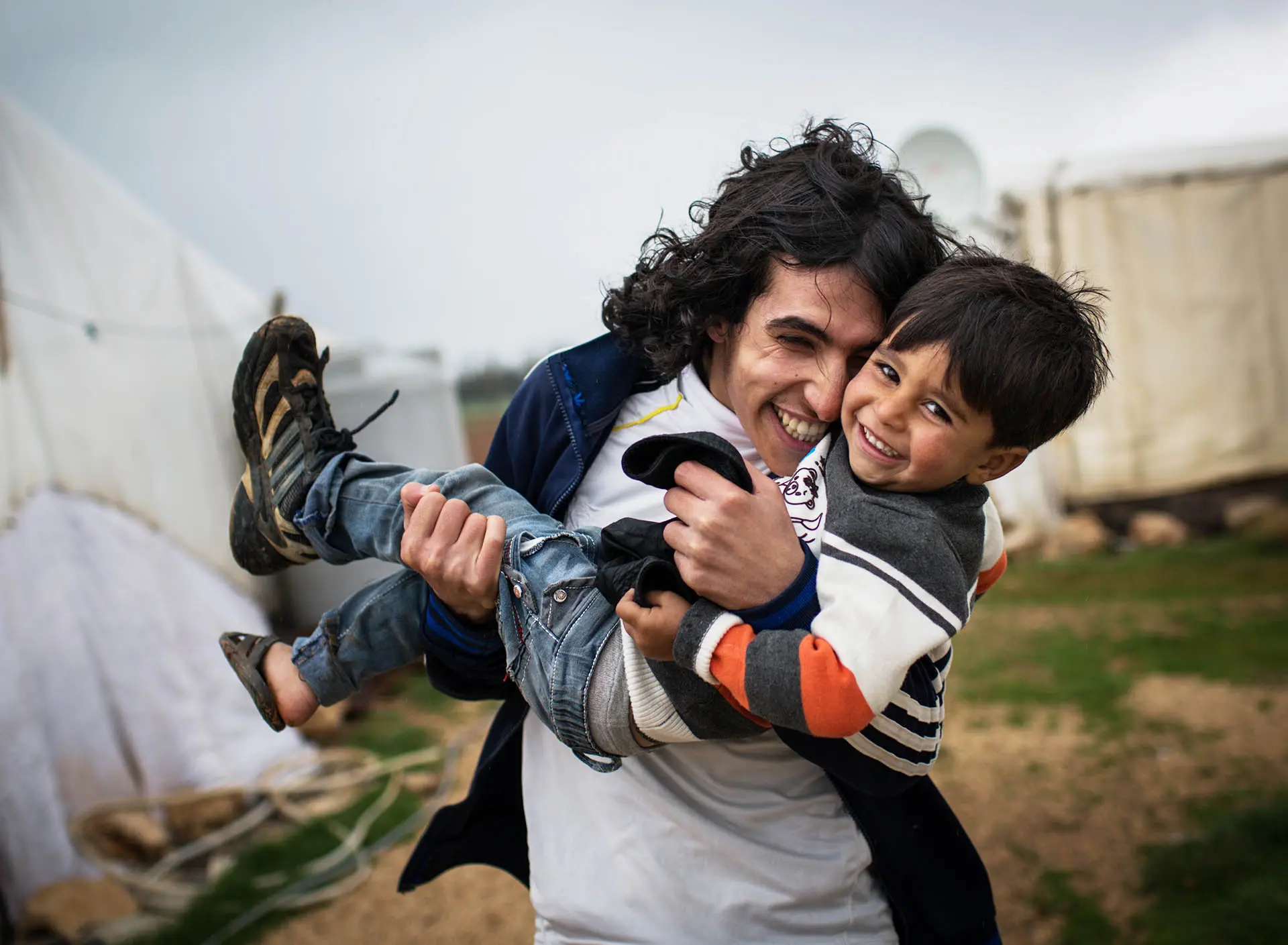 3 year-old Ashraf, and his brother Hany, pictured outside their family's shelter at an informal tented settlement in the Bekaa Valley, Lebanon, on 12 March 2014