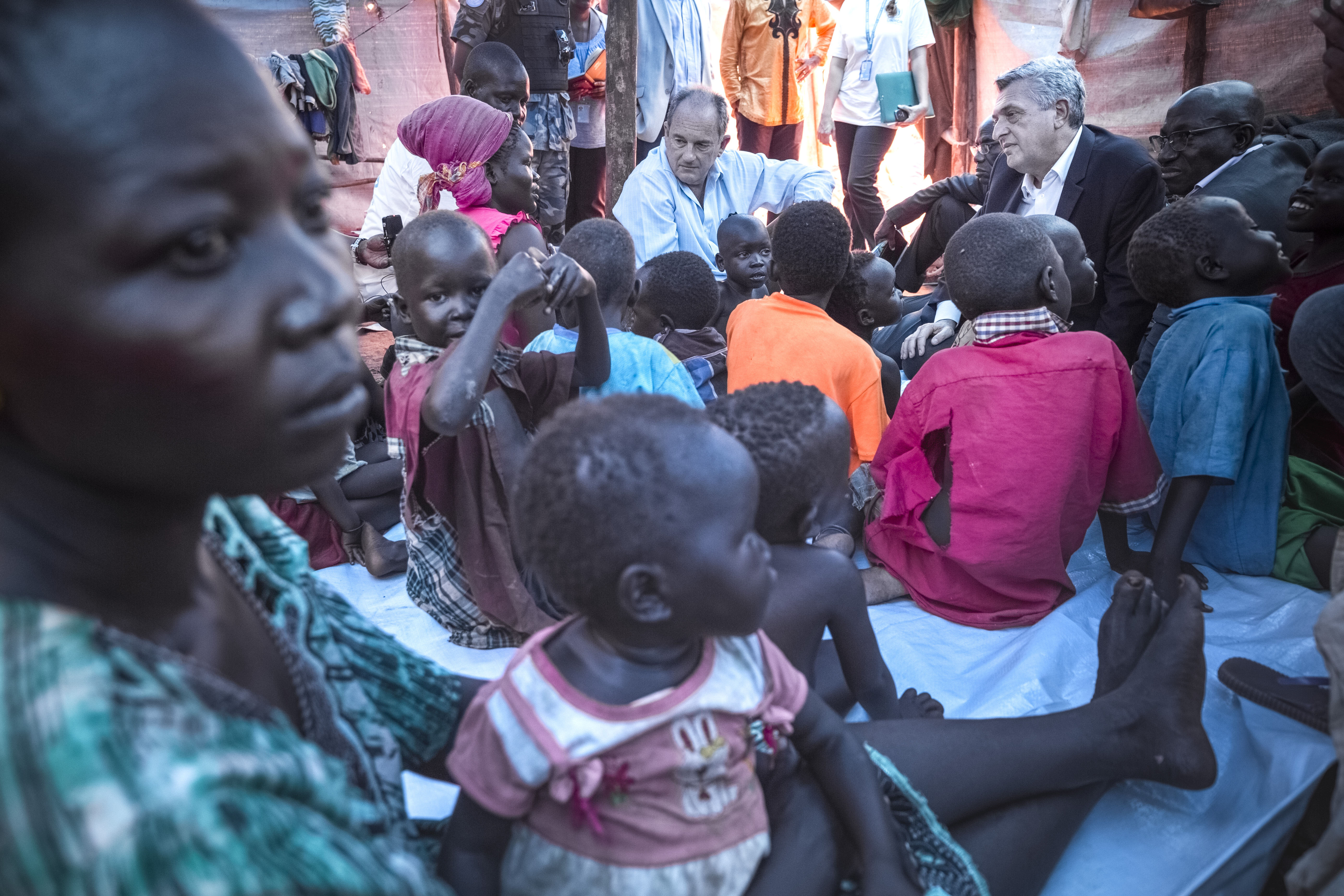 "We want peace." Women and children talk with United Nations High Commissioner for Refugees Filippo Grandi and the head of the UN's peacekeeping mission in South Sudan, David Shearer at POC3 camp for internally displaced persons in Juba. ; The refugee crisis in South Sudan has displaced almost 4 million people since the conflict began in December 2013. In July 2016, the disastrous breakdown of peace efforts in South Sudan contributed to a mass outflow of people fleeing for their lives. By June 2017, nearly 1.87 million people had fled the country and a further 1.9 million were internally displaced. Two-thirds are under the age of 18 and many of them have witnessed brutal violence, fleeing their villages when armed groups burned down their houses and killed their neighbours. During a three-day visit to the world's fastest growing displacement crisis, UNHCR chief Filippo Grandi said peace is the only lasting solution for the millions of displaced.