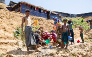 Rohingya refugee, Anu Mia (left), age 30, struggles to get clean water and sanitation in Kutupalong Refugee Camp Extension. © UNHCR/Roger Arnold