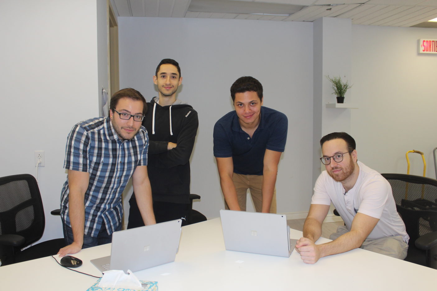 Team LUNA AI with Abdulla Daoud (right), Executive Director of DevBloc at The Refugee Centre in Montreal.