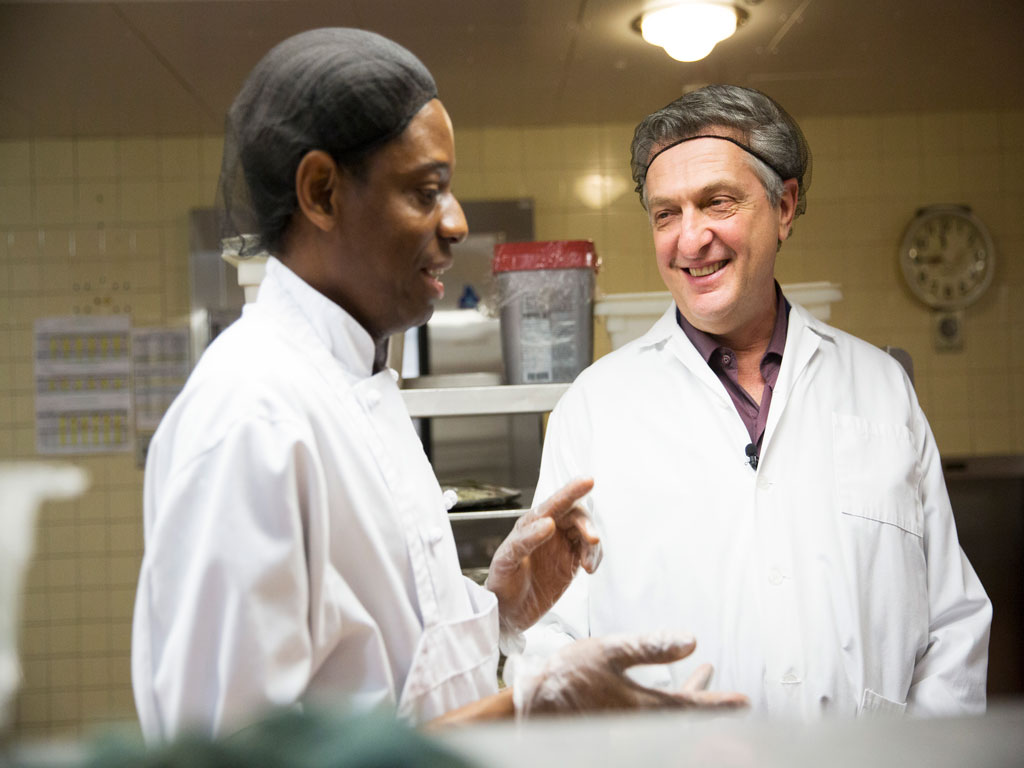 UN High Commissioner for Refugees Fillipo Grandi (right) met with Congolese refugee Jean-Claude Puati at a Montreal hospital where he works as a cook. © UNHCR/Michelle Siu 