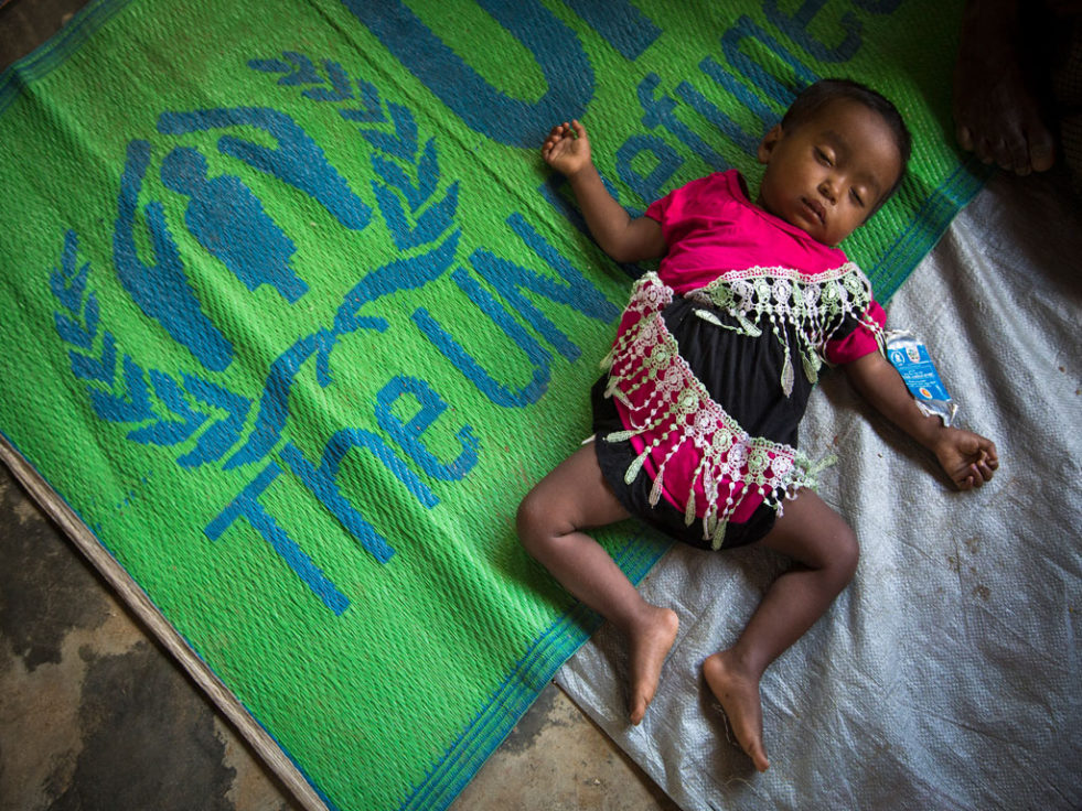 A young baby sleeps soundly among some 5,000 people being relocated to a new site near Kutupalong refugee camp. ©UNHCR/Roger Arnold