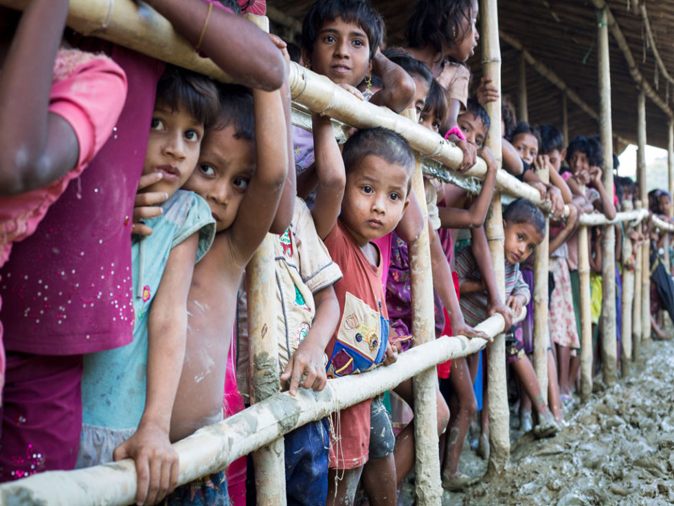 Hundreds of Rohingya children queue for food in the muddy and unsanitary Unchiprang makeshift camp in Bangladesh. They came by boat or walked barefoot for days. wading through vast rice fields. ©UNHCR/Roger Arnold