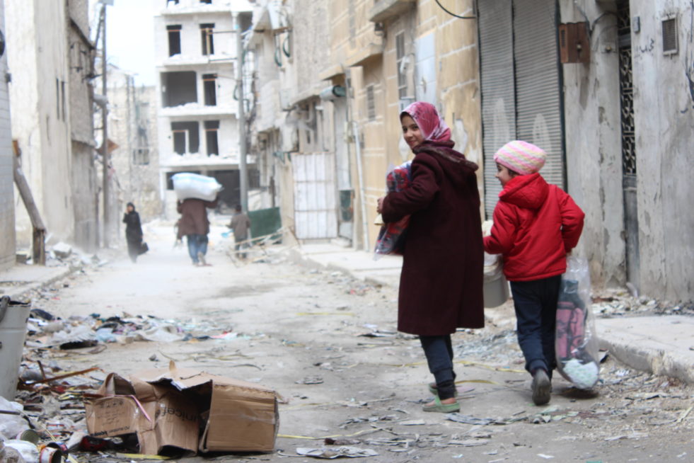 In the badly damaged Al-Shaar neighbourhood in East Aleppo, returnee families and displaced residents receive UNHCR relief assistance at a distribution point run by the Al Ihsan charity. ; Around 5,000 families who have returned to the war-damaged homes and buildings in Al-Shaar approach UNHCR’s aid distribution point every day to receive the badly needed assistance. Our emergency distribution program provides core relief Items including mattresses, plastic sheets, kitchen sets, jerrycans, blankets and solar lamps. As of mid-March 2017, over 120,000 people have received relief items in Aleppo. UNHCR’s emergency stocks are being continually replenished to meet the needs. The war in Syria has forced nearly 5 million people to seek refuge in neighbouring countries. A further 6 million have been displaced within Syria’s borders. Of the estimated 4 million inhabitants of Aleppo, less than 1.5 million remain. Some 400,000 were displaced by the vicious battle for control of the city which left 40 per cent of buildings and infrastructure destroyed beyond repair.