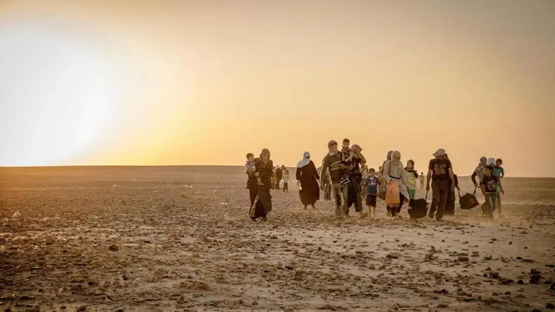 People walking across dessert