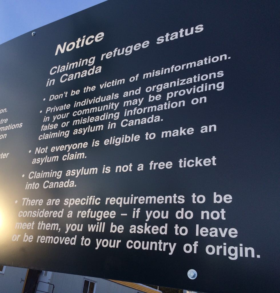 a picture of a sign that reads "Notice, Claiming refugee status in Canada, don't be a the victim of misinformation, Private individuals and organization in your community may be providing false or misleading information on claiming asylum in Canada, Not everyone is eligible to make an asylum claim, Claiming asylum is not a free ticket into Canada, There are specific requirements to be considered a refugee--if you do not meet them, you will be asked to leave or be removed to your country of origin."