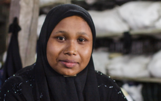 A portrait of a woman wearing a black hijab