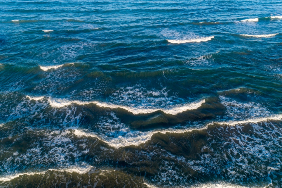 Lapping waves on the Mediterranean Sea cresting over into several white caps