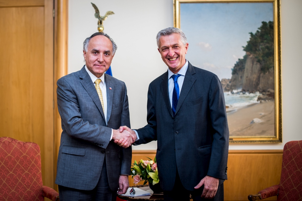 UN High Commissioner for Refugees, Filippo Grandi, shakes hands with Chilean politician