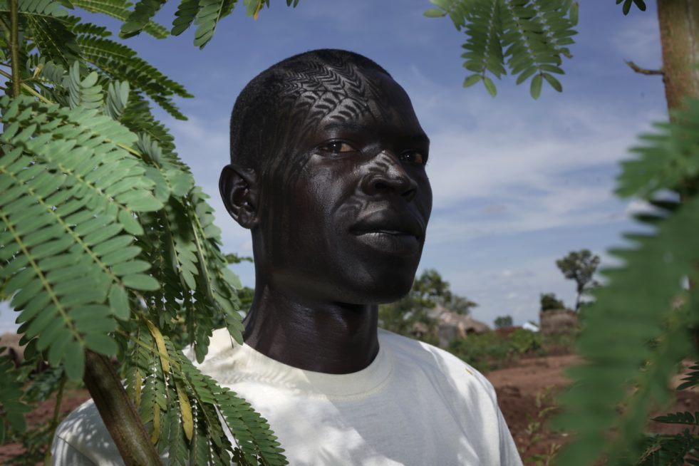 A portrait of a refugee man who is a tree planter and environmentalist