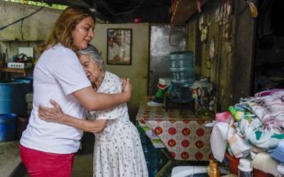 Trans woman hugs elderly woman at a home in El Salvador