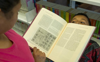 A woman reads her son a book in Mexico