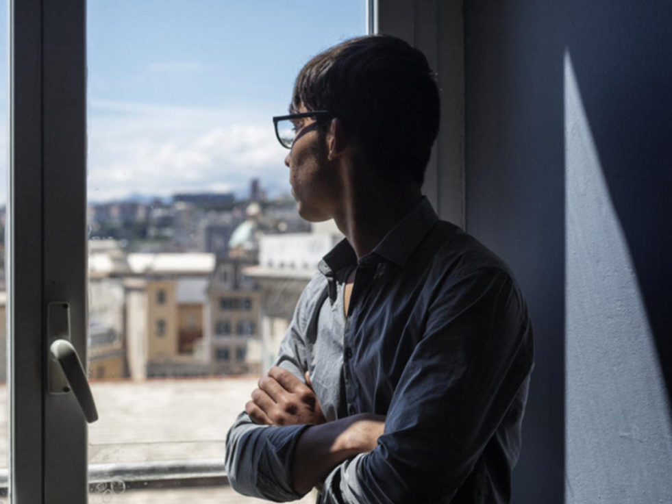 An Afghan boy looks out a window