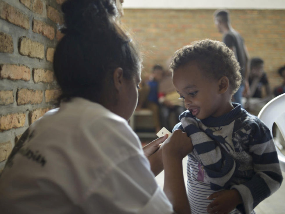 A small boy from Libya is seen by a doctor