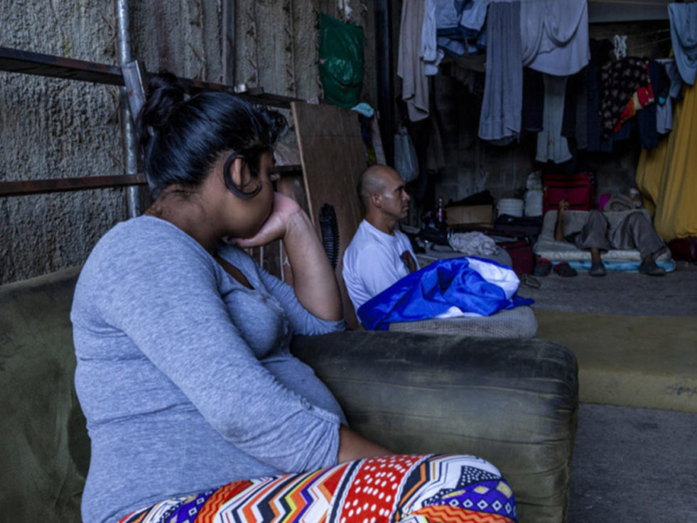 A woman in Nicaragua sits in her home