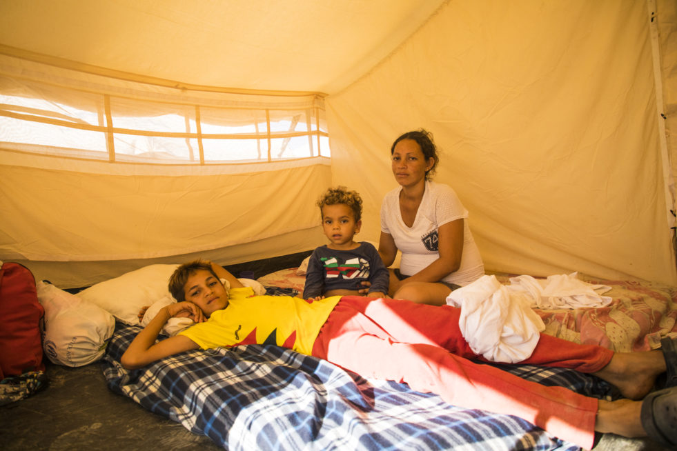 Venezuelan family sits on a mattress