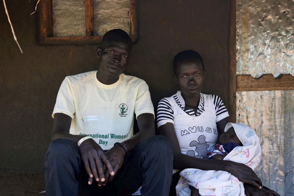 A man from South Sudan sits with his wife