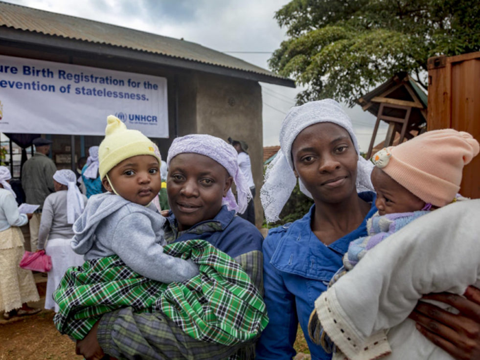 Two women who were stateless hold their children