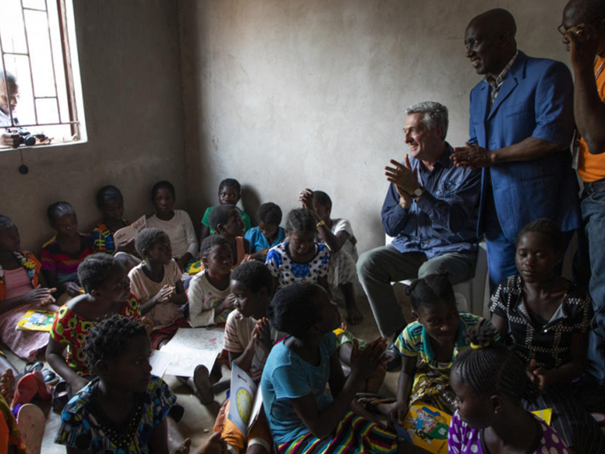 Refugee Chief sits with children in Zambia
