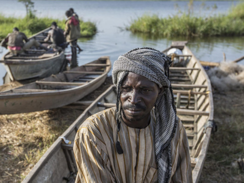 A man sits on a fishing boat