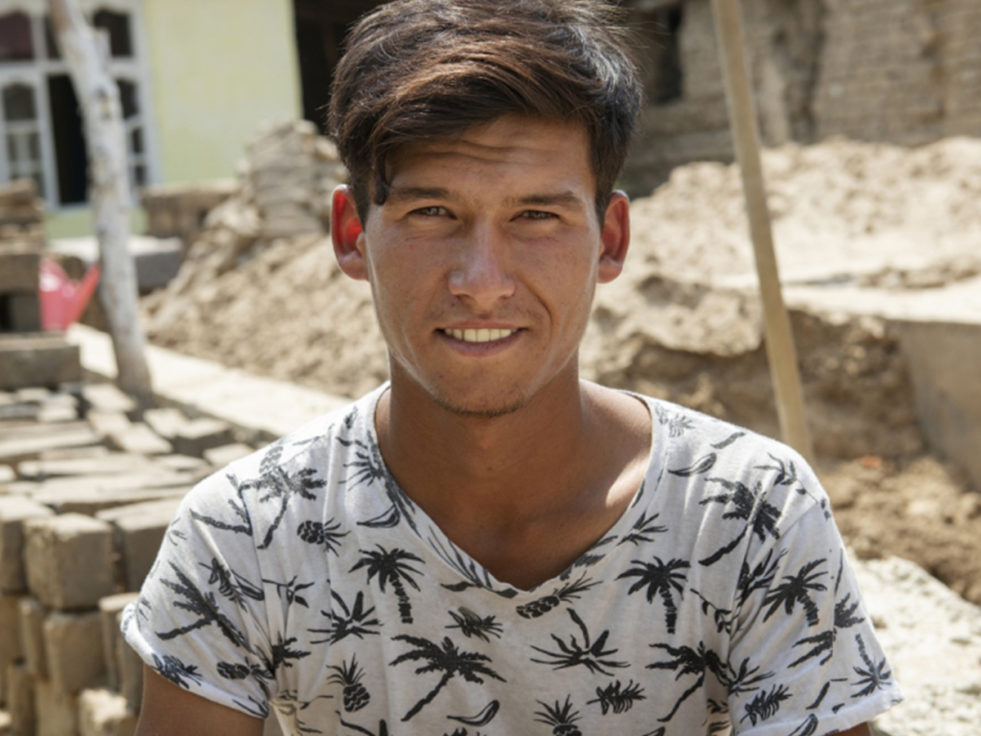 A man who was stateless and can now be a doctor smiles at the camera