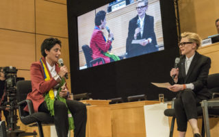 Two women sit and talk about statelessness