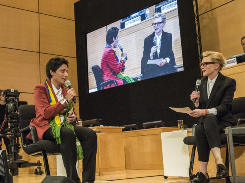 Two women sit and talk about statelessness