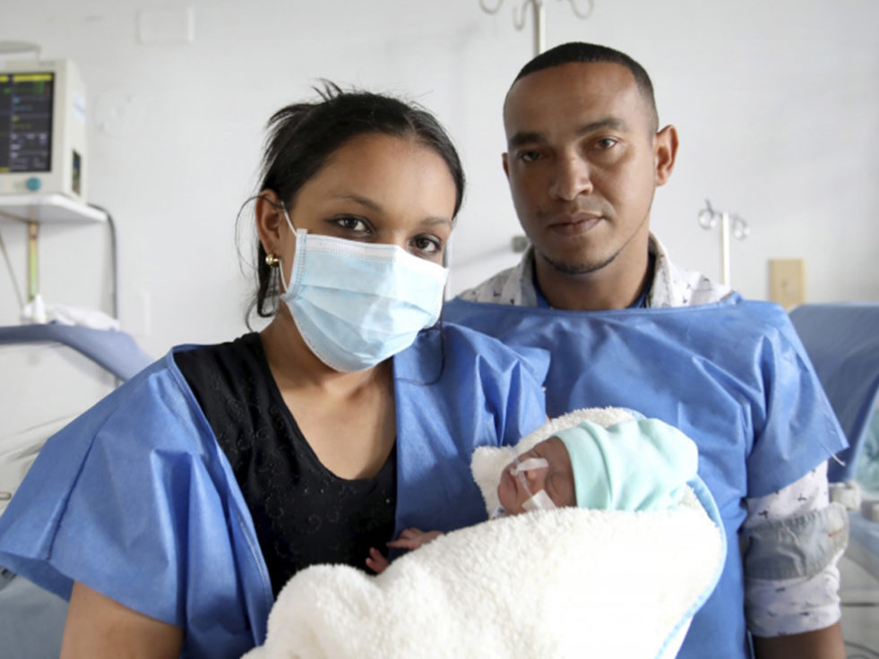 Parents from Venezuela hold their newborn baby