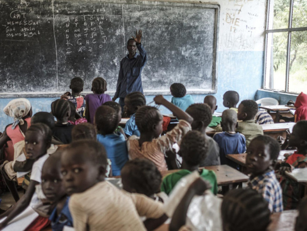A teacher lectures at a blackboard in Ethiopia