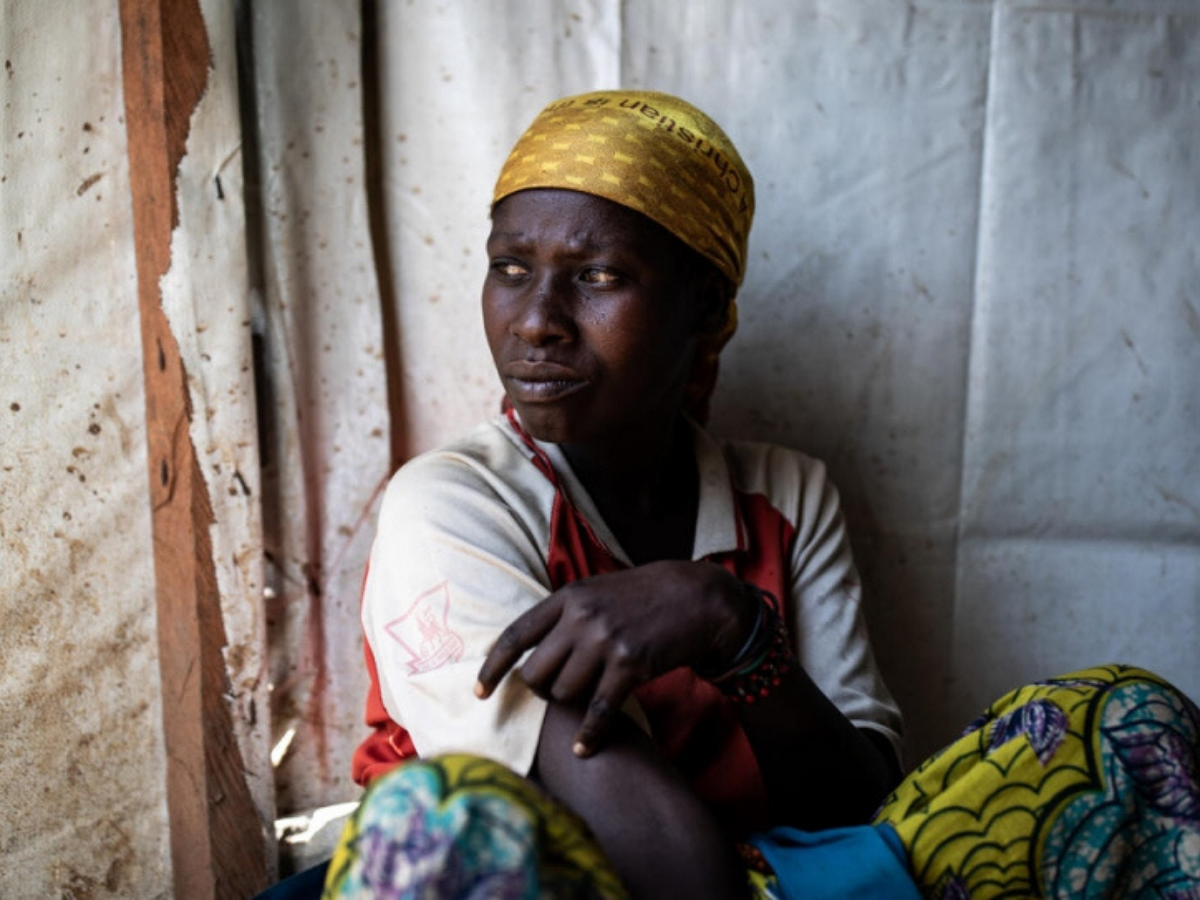 A woman from the Congo sits and looks away