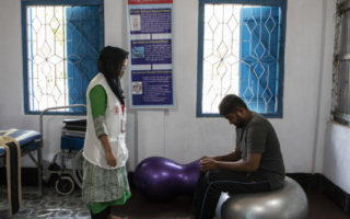 A woman treats a man in a clinic