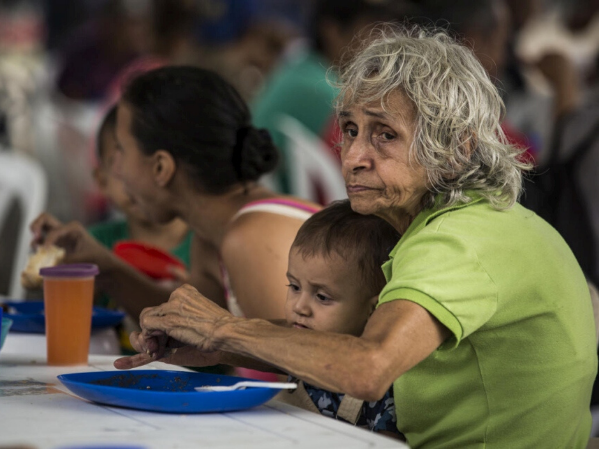 Venezuelan refugees eat a meal at a community kitchen in Cúcuta, Colombia